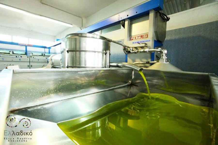 close-up of olive oil flowed from olive oil press machine at Elladiko plant